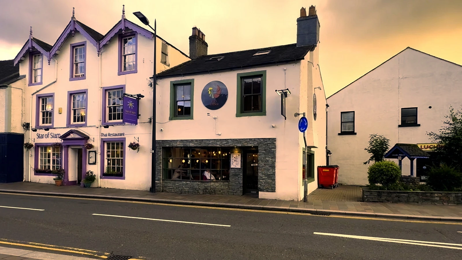 The Piri Fresco shopfront on Main Street at dusk